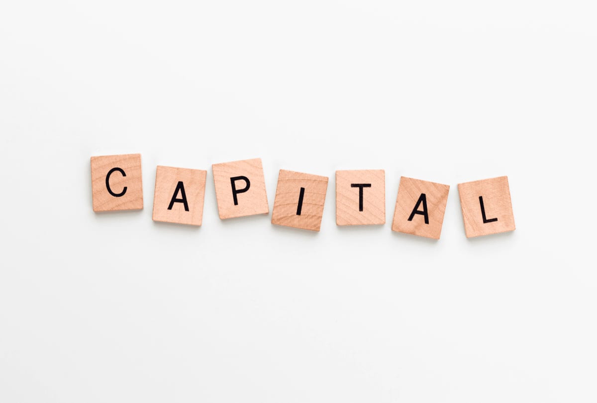 Capital planning concept arranged on a clean working surface