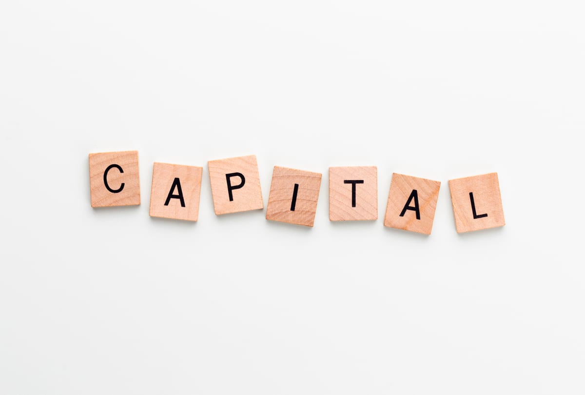 Capital planning concept arranged on a clean working surface
